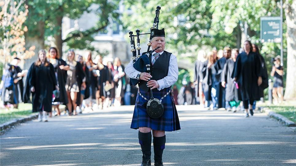 Convocation 2024 Bagpiper Leading the Procession