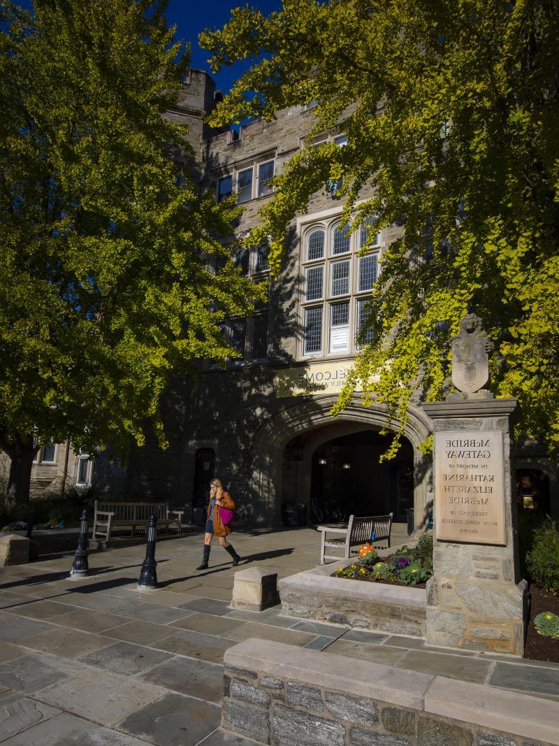 student walking through Pembroke Arch