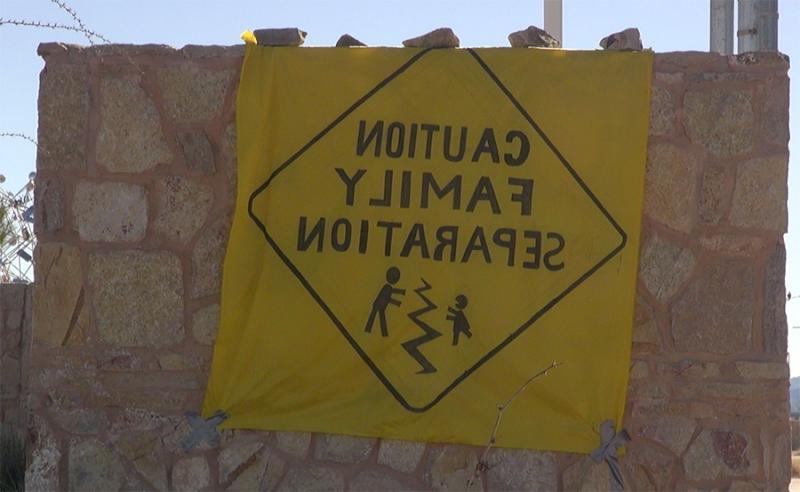 Protest sign displaying a drawing of a road sign, reading "Caution Family Seperation"