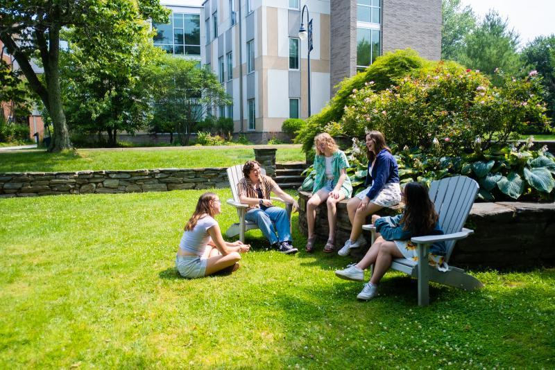 Students sitting in the Sunken Garden with New Dorm in the background